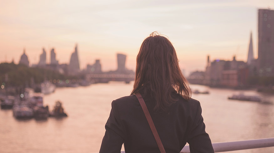 Woman looking out into the city. Why do I feel so empty and numb?