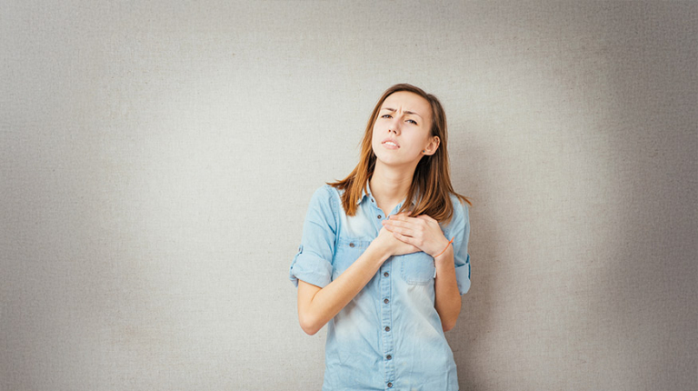 Women trying to feel her feelings, hand on her heart